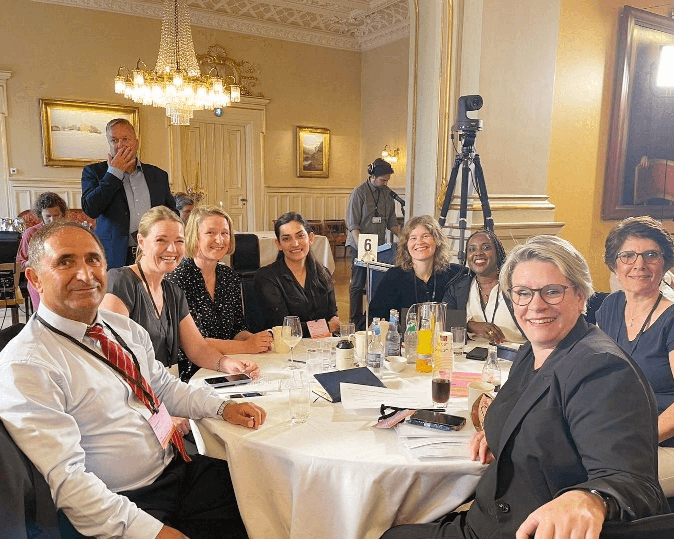 Participants gathered around a table during a meeting or event in Norway